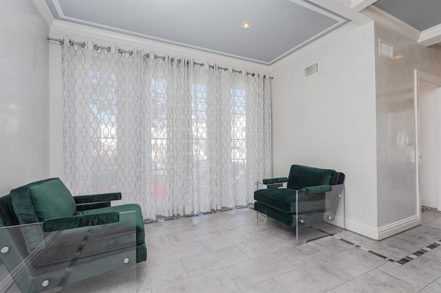 living area with tile patterned floors and ornamental molding