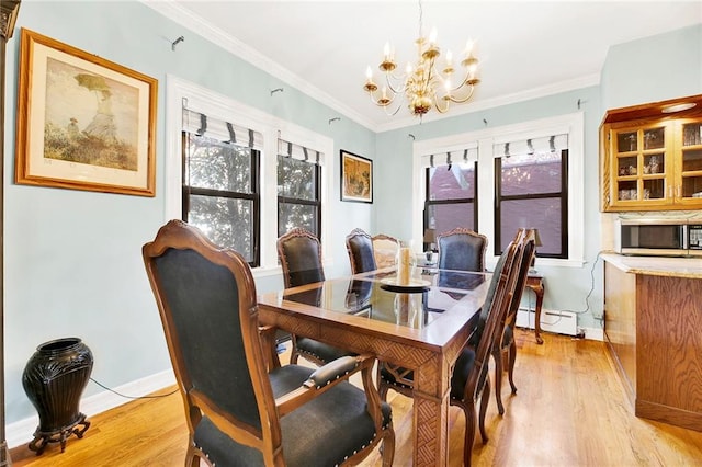 dining space featuring a chandelier, light hardwood / wood-style floors, plenty of natural light, and ornamental molding