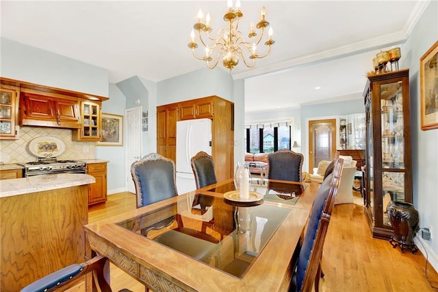 dining area with light wood-type flooring and a chandelier