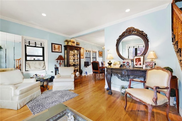 sitting room featuring wood-type flooring and ornamental molding