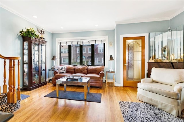 living room with light hardwood / wood-style flooring and ornamental molding