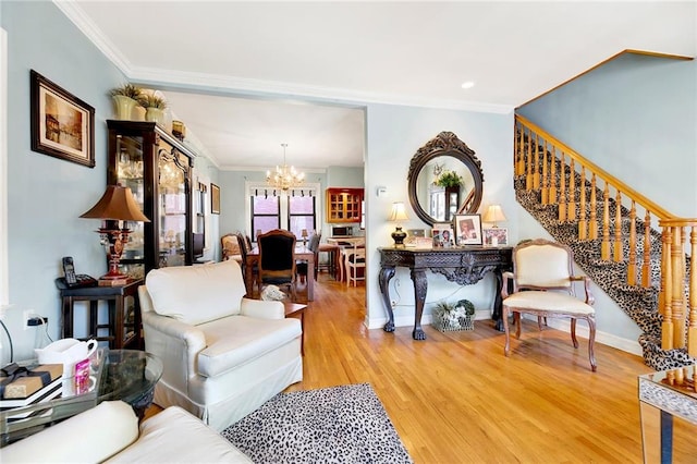 living room featuring a chandelier, ornamental molding, and hardwood / wood-style floors