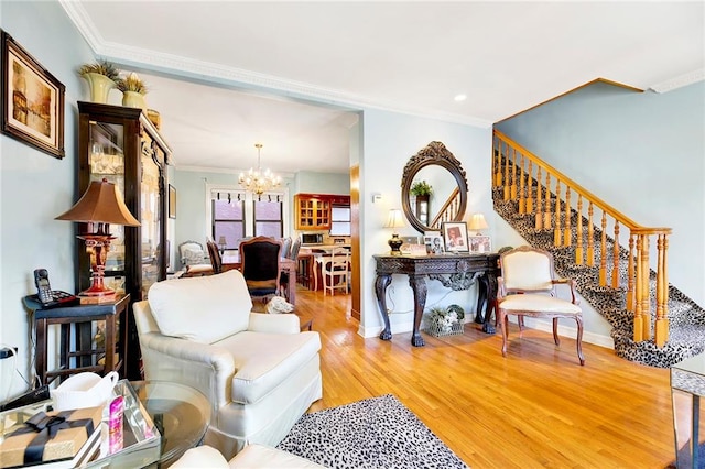 living room featuring an inviting chandelier, crown molding, and hardwood / wood-style flooring