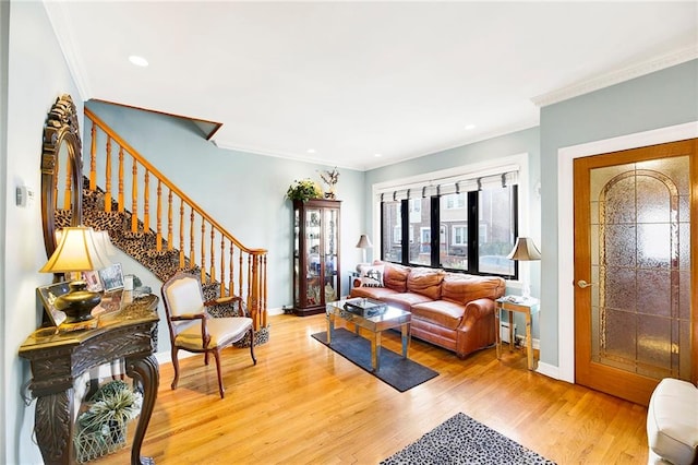 living room with wood-type flooring and crown molding