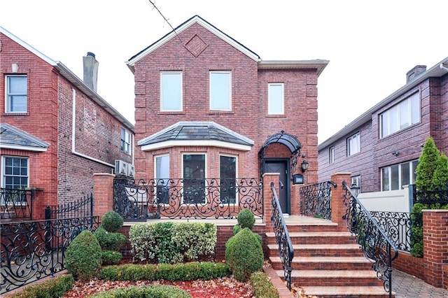 view of front of property featuring fence and brick siding