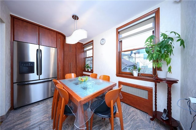 kitchen with pendant lighting, dark wood finished floors, and stainless steel refrigerator with ice dispenser