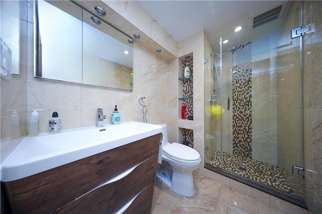 full bath with vanity, a shower stall, toilet, and visible vents