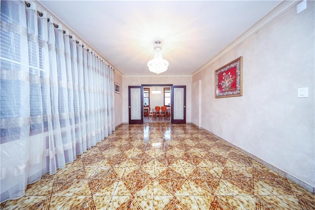 hallway featuring crown molding and a chandelier