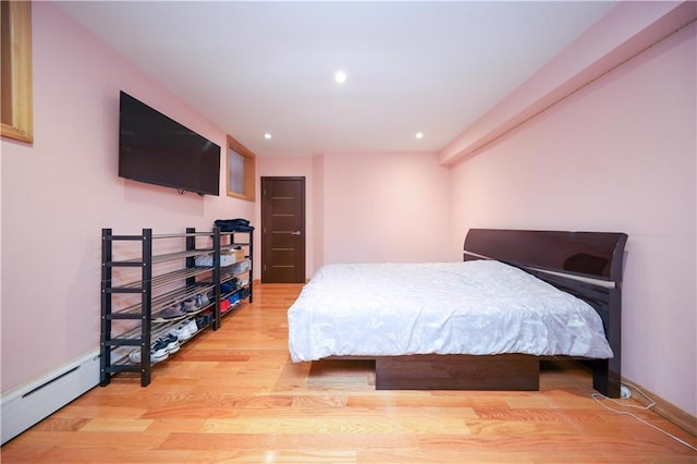 bedroom featuring recessed lighting, a baseboard radiator, baseboards, and light wood finished floors