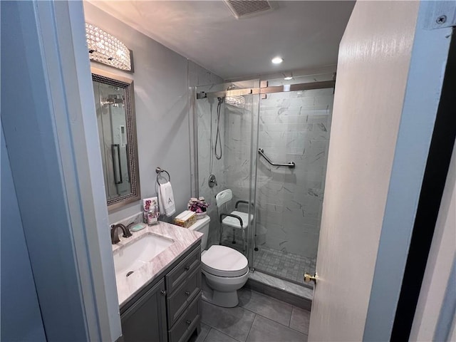 bathroom featuring vanity, toilet, a shower with door, and tile patterned flooring