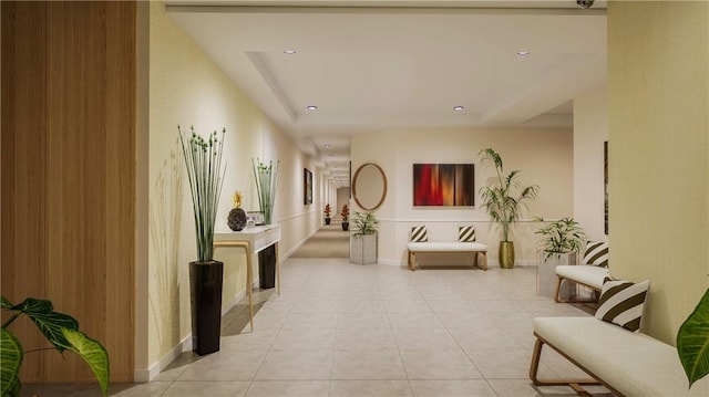 corridor featuring a tray ceiling and light tile patterned floors