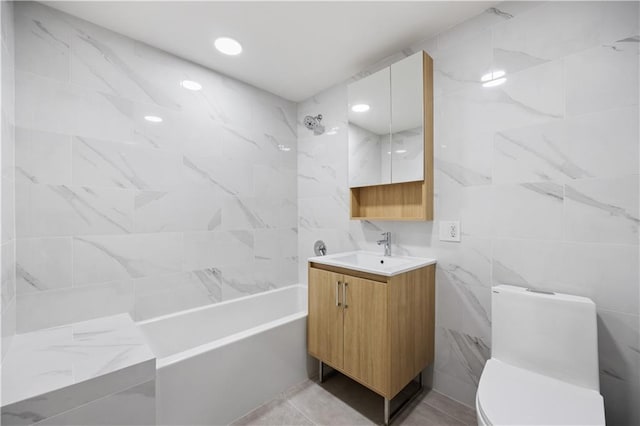 full bathroom with bathtub / shower combination, vanity, toilet, and tile walls