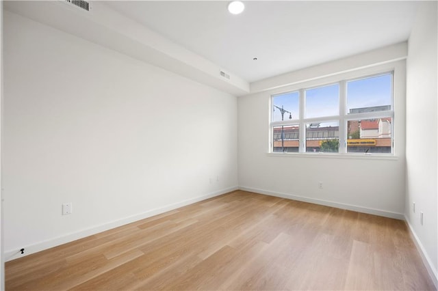 unfurnished room featuring light hardwood / wood-style floors