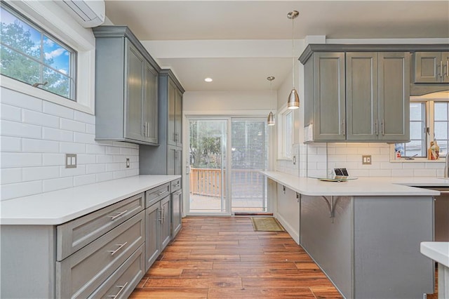 33 Wellington Ct, Brooklyn, NY 11230 - kitchen featuring wood finished floors, gray cabinets, tasteful backsplash, and recessed lighting