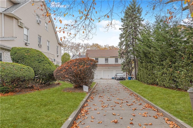 exterior space with a lawn and concrete driveway