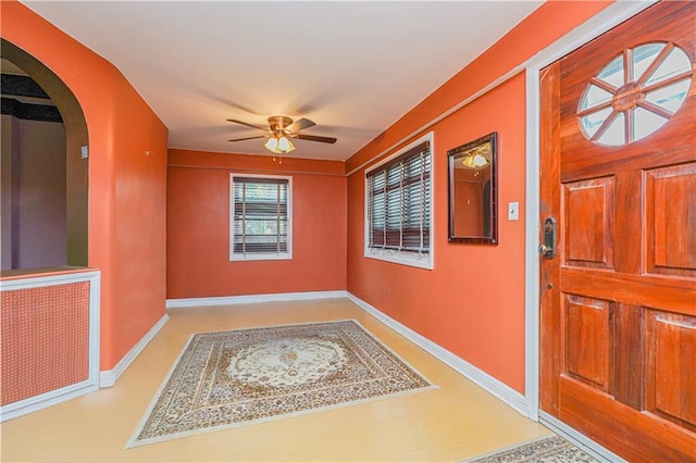 entrance to property with a ceiling fan
