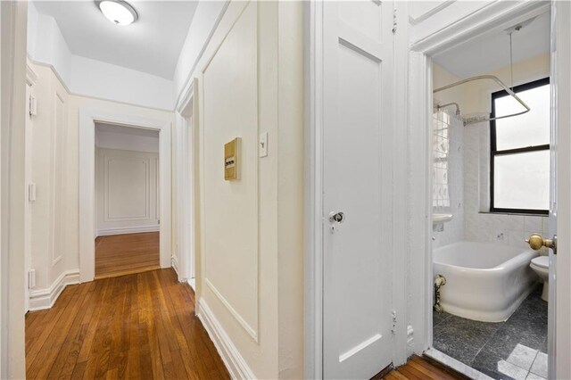 kitchen featuring light stone counters, sink, light brown cabinets, light tile patterned floors, and dishwasher