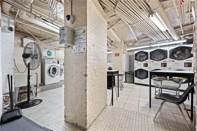 basement with light tile patterned flooring, independent washer and dryer, and stacked washer and clothes dryer