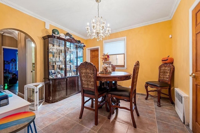 dining area featuring arched walkways, a notable chandelier, crown molding, and radiator heating unit