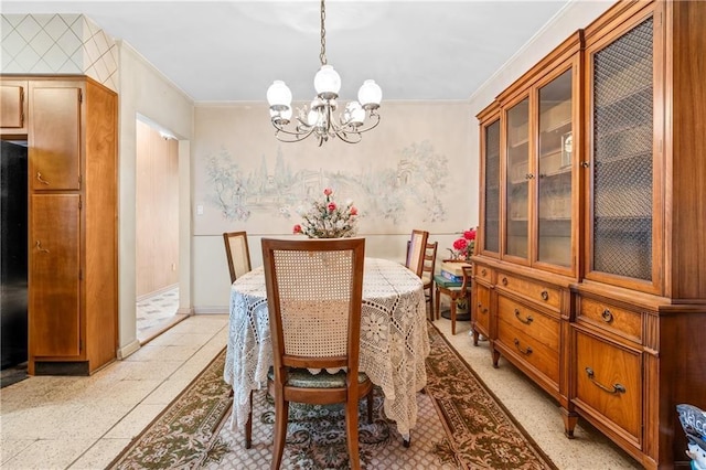 dining room featuring baseboards, wallpapered walls, ornamental molding, light speckled floor, and a chandelier