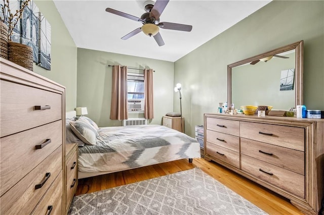 bedroom with light wood-type flooring and a ceiling fan