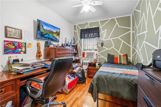 bedroom featuring light wood finished floors, cooling unit, and radiator