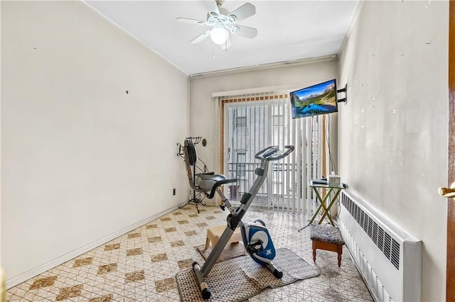 exercise room with radiator, baseboards, and ceiling fan