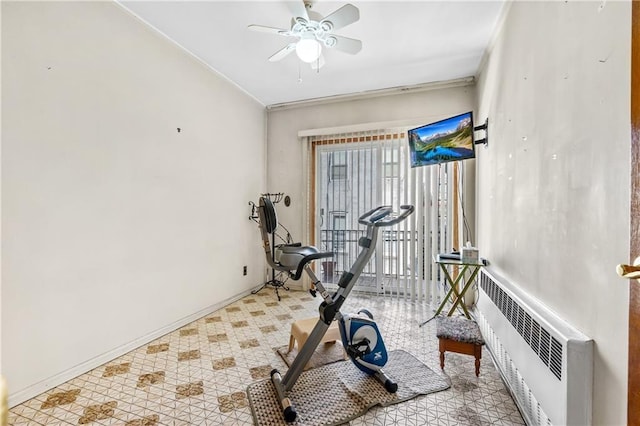 exercise room with baseboards, radiator, ornamental molding, and ceiling fan