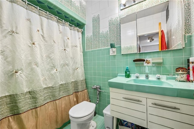 full bath with tile walls, toilet, a shower with curtain, vanity, and tile patterned flooring