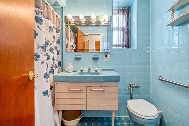 bathroom featuring toilet, tile walls, tile patterned flooring, and vanity