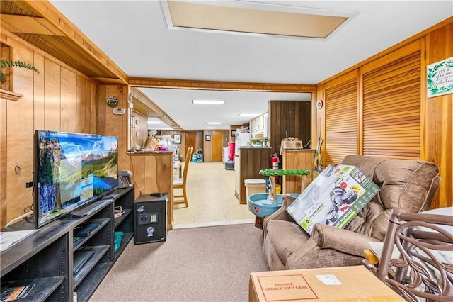 living room with carpet flooring and wood walls