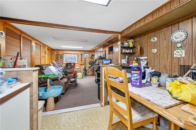 carpeted dining room with wooden walls