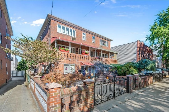 view of front of property with brick siding and a fenced front yard