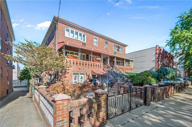 view of front of property with brick siding and fence private yard