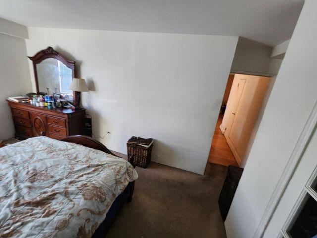 bedroom featuring dark colored carpet