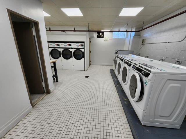 laundry room featuring washing machine and clothes dryer