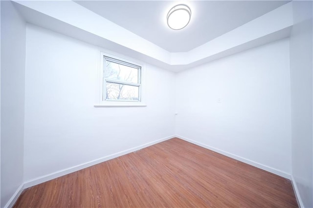 empty room featuring baseboards and wood finished floors