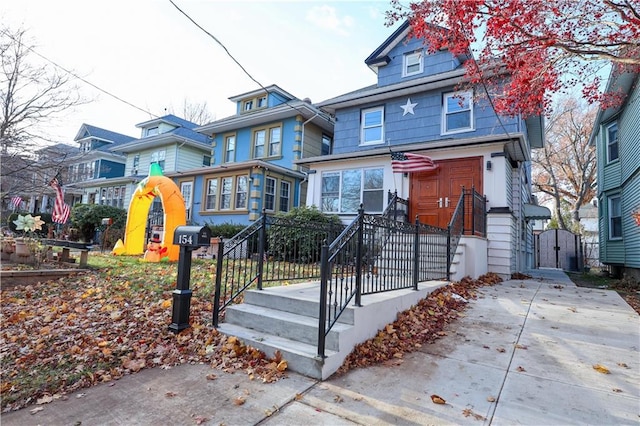 view of front of house with a gate and fence