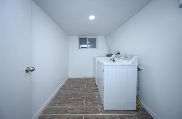 washroom featuring recessed lighting, laundry area, baseboards, wood tiled floor, and washer and clothes dryer