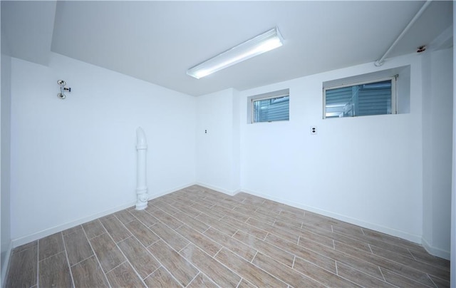 spare room with wood tiled floor and baseboards