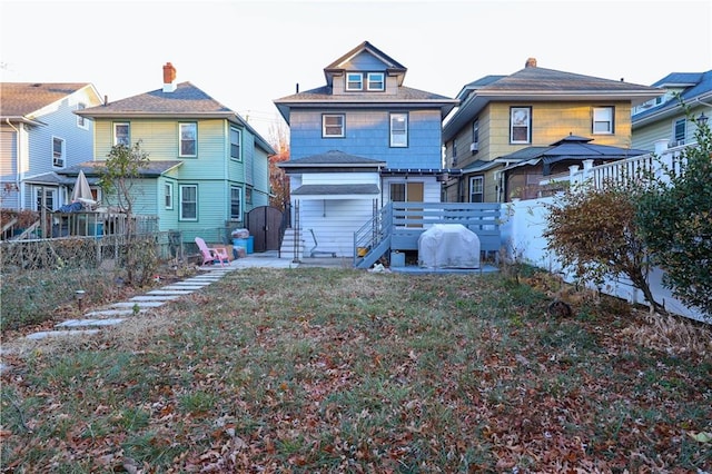 rear view of house with a fenced backyard