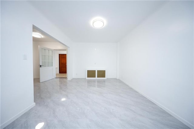 unfurnished room featuring baseboards