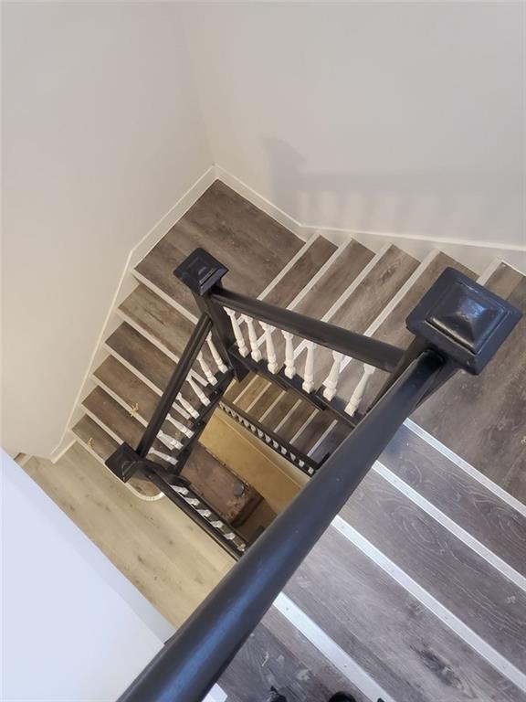 stairs with hardwood / wood-style flooring