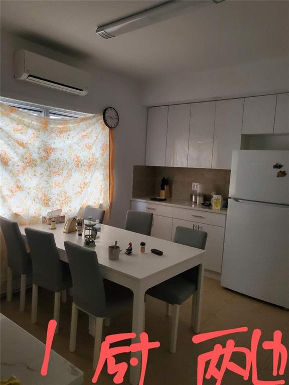 kitchen featuring white fridge, white cabinetry, backsplash, and a wall mounted AC