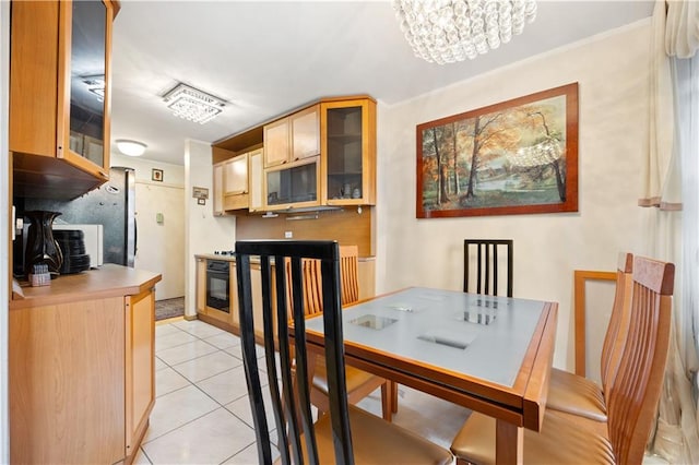 dining space with light tile patterned floors and a chandelier