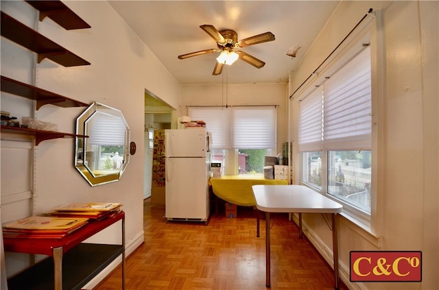 dining area with plenty of natural light, ceiling fan, and light parquet floors