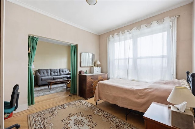 bedroom featuring light hardwood / wood-style flooring and ornamental molding