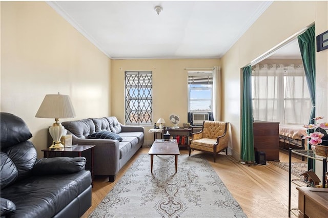 living room featuring light wood-type flooring, cooling unit, and ornamental molding