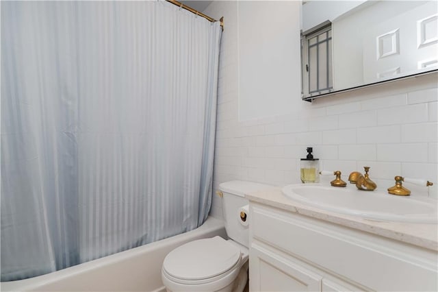 bathroom featuring shower / bath combo with shower curtain, toilet, tile walls, and vanity