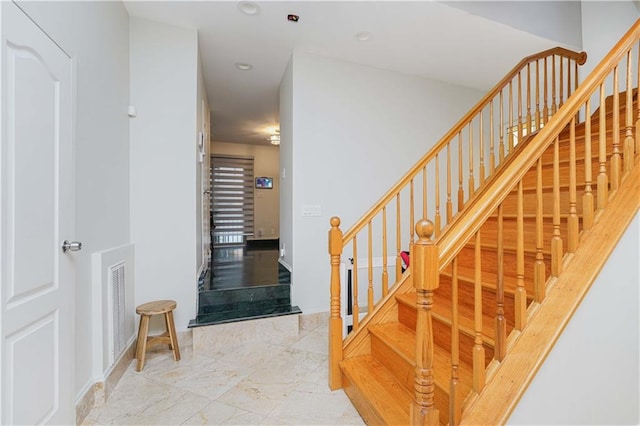 staircase featuring recessed lighting, visible vents, and marble finish floor